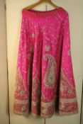 Two vintage Indian wedding skirts, one heavily embroidered and beaded pink silk Indian wedding skirt