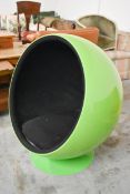 A vintage Eero Aarnio designed Ball Chair in a lacquered lime green finish on a swivel base.