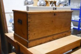 A 19th century pine trunk with twin metal carrying handles on a plinth base. H.51 x W.102.5 x D.48cm