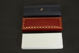 Three pens in boxes, including a cased Cartier 