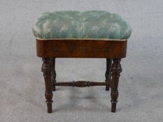 A Victorian James Shoolbred figured walnut piano stool, the buttoned seat upholstered in blue
