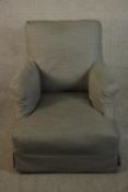 A small armchair, with a grey fabric cover.