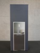 A boxed Georg Jensen polished stainless steel Cobra floor candleholder, medium. H.54 W.21 D.21cm (
