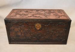 A Chinese camphorwood chest, with key pattern borders, carved with dragons chasing a flaming pearl