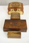 A collection of four treen boxes, including a Māori carved mask design box with abalone shell