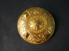 An Etruscan style 14 carat yellow gold shield design brooch with wire detailing and four mythical