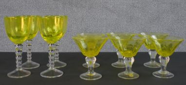 Two sets of yellow blown art glass stemmed drinks glasses, a set of six by Biot, with labels. H.20