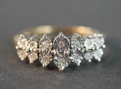 A 9ct yellow and white gold diamond dress ring set with fourteen round eight cut diamonds in