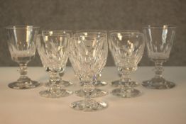 A set of seven 19th century Waterford crystal wine glasses, with cut bowls and a single knop, etched