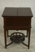 An Edwardian Maple & Co 'surprise' drinks cabinet, the lid with two flaps enclosing a fitted