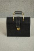 An Italian calf leather and red suede travelling jewellery case, with brass clip lock and key. H.