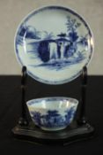 A Chinese Nanking Cargo blue and white porcelain tea bowl and saucer on ebonised stand. (Lot 5064 at