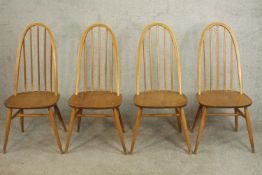 A set of four Ercol elm and beech hoop back Quaker dining chairs, with turned legs and H stretchers,