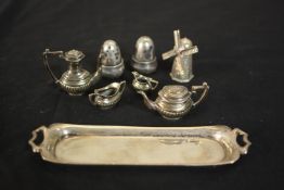 A novelty miniature gadrooned four piece silver tea set on twin handled tray along with a