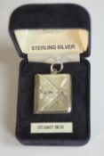 A sterling silver engraved stamp box in the form of an envelope with hinged flap. H.3.5 W.2cm.