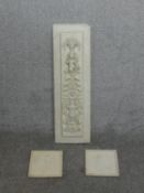 A decorative plaster panel with urn and putti design along with two smaller plaster relief plaques