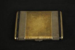 An Art Deco Fortnum & Mason Ltd, gilded silver engine decorated compact with black enamel