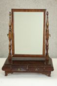 A 19th century mahogany toilet mirror with a rectangular mirror plate on turned columns over two