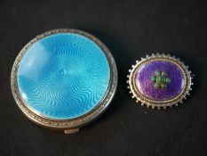A silver and pale guilloche enamel engine decorated compact with push catch (mirror and compact
