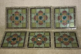 A set of six early 20th century coloured lead lined stained glass window panes with stylised