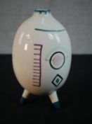 A mid-century hand painted ovoid form vase on tripod legs decorated with an abstract design. H.25cm