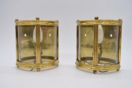 A pair of brass mounted and glass demi lune wall hanging lights with glass panels, electrified. H.19