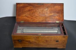 A 19th century inlaid walnut music box on shaped bracket feet. (In complete and working