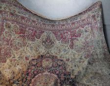 A large Persian Meshed carpet with central medallion on a biscuit field with scrolling foliate