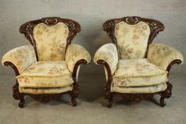 A pair of late 20th century carved and lacquered armchairs, upholstered in cream coloured foliate
