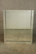A contemporary Venetian style rectangular wall mirror with a bevelled mirror plate within an