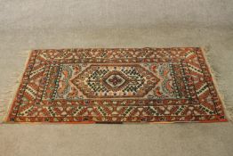 An Eastern Ziegler style woollen rug with central hexagonal lozenge within geometric style border.