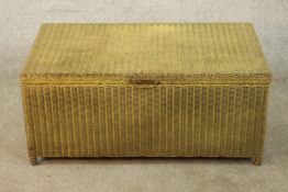 A 1930s painted Lloyd loom style ottoman/ blanket trunk raised on short supports, H.41 W.91 D.53cm.