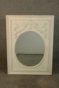 A 19th century style white painted mirror, the oval mirrored plate in a rectangular frame with