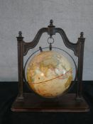 A Thomas Blakemore reproduction terrestrial globe, hanging from a cast iron frame on a mahogany