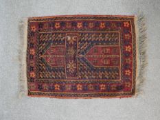 A red ground hand made Herat Belouch rug. W.68 D.53cm