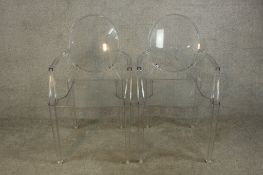 A matching pair of Philippe Stark Kartell Louis Ghost Christal open arm chairs raised on square