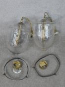 A pair of contemporary Hundi style glass storm lanterns, with brass fittings, the bell shaped