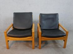 A pair of mid 20th century Cornwall - Norton teak open armchairs, model 10 / 11, with black