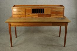 A mid 20th century three drawer writing table/desk raised on square tapering supports. H.109 W.167