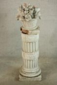 A late 19th / early 20th century white tin glazed pottery garden pedestal; moulded in the form of