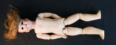 An early 20th century C. M. Bergmann bique porcelain headed composition articulated doll,