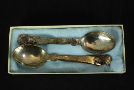 A pair of boxed Georg Jensen plannished silver spoons each engraved with shell decoration and set