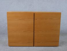 A circa 1970s Tapley teak cupboard, with two cupboard doors enclosing a shelf, bearing maker's