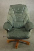 A 20th century pale green leather swival and counter leaver arm chair raised on five splayed