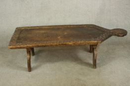 A mid 20th century carved Indian hardwood low table raised on stylised trestle supports. H.40 W.