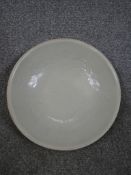 A Chinese Dingware porcelain bowl, the interior incised three claw flying dragon and exterior with