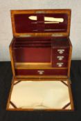 A 1930's oak stationery/writing box, the hinged lid opening to reveal fitted interior and the hinged