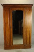 A 19th century mahogany single mirrored door gentlemen's wardrobe, opening reveal shelves and