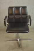 A Walter Knoll design black leather open arm revolving office, raised on four branch chrome plated