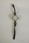 An Art Deco silver watch with white enamel dial with roman numerals and stop watch dial. Hallmarked: